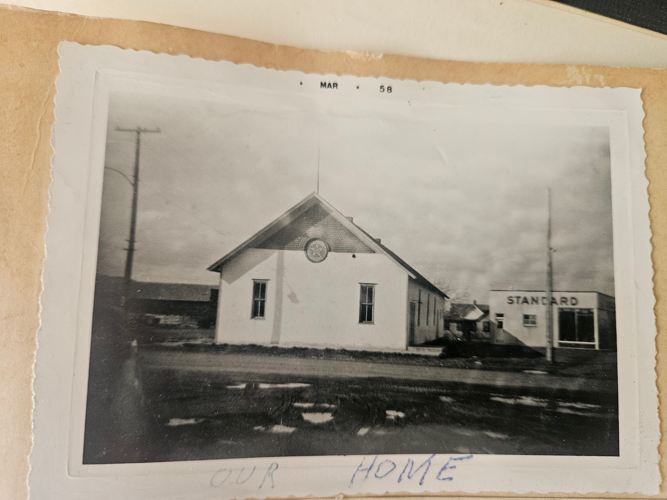 The Post 71 building in Fromberg, Montana — circa 1958. The American Legion emblem is visible on the gable of the historic Fromberg Opera Hall.